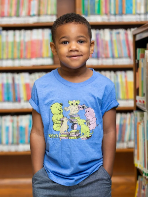 Photograph of a child wearing an illustrated library T-shirt